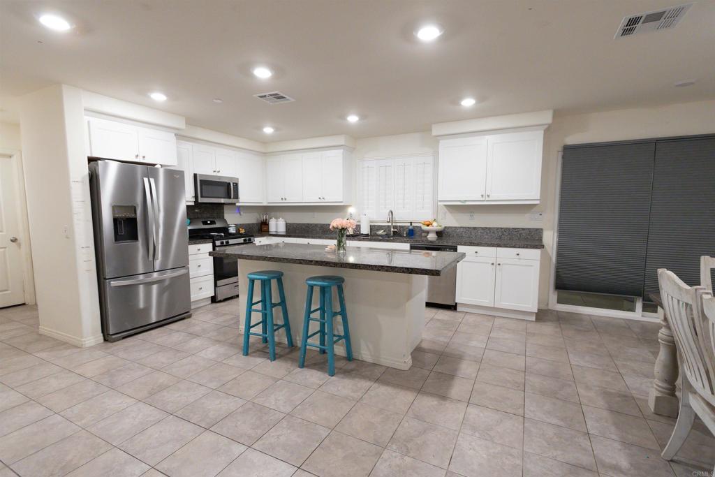 32097 Rambling Court Winchester, CA 92596 - Photo 8 of 62 a kitchen with stainless steel appliances a refrigerator sink and microwave