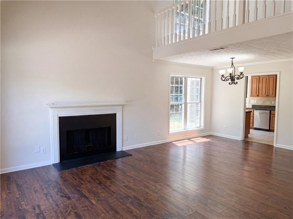722 Ridgetop Road Bethlehem, GA 30620 - Photo 5 of 23 an empty room with wooden floor fireplace and windows