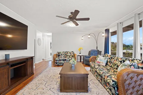 a living room with furniture fireplace and flat screen tv