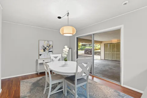 a dining room with furniture and window