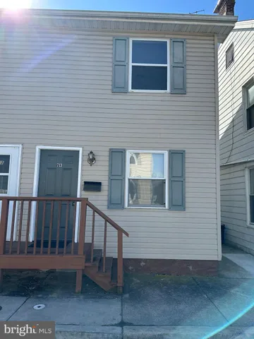 a view of a house with a small deck