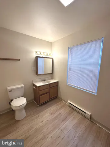 a white toilet sitting next to a bath tub and a shower