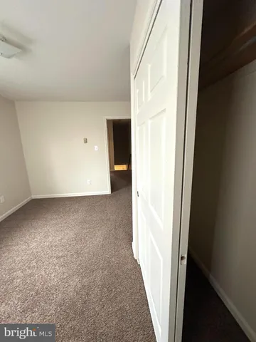a view of an empty room and closet area