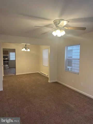 a view of a livingroom with a ceiling fan and window