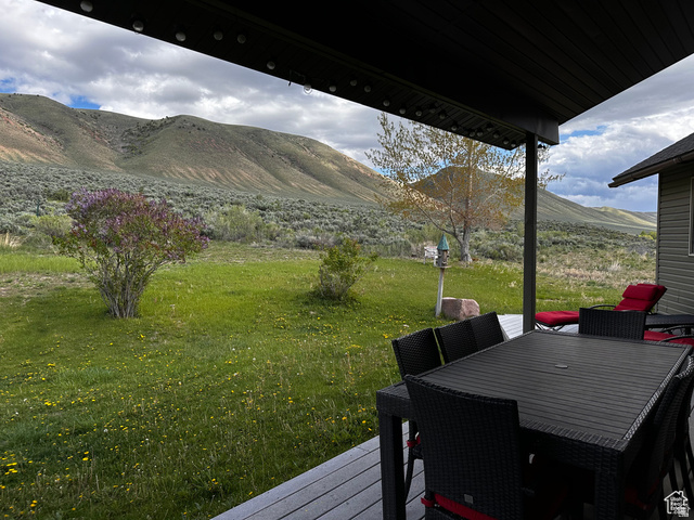 1940 East Shore Road St. Charles, ID 83272 - Photo 60 of 64 Wooden deck with a yard, outdoor dining area, and a mountain view