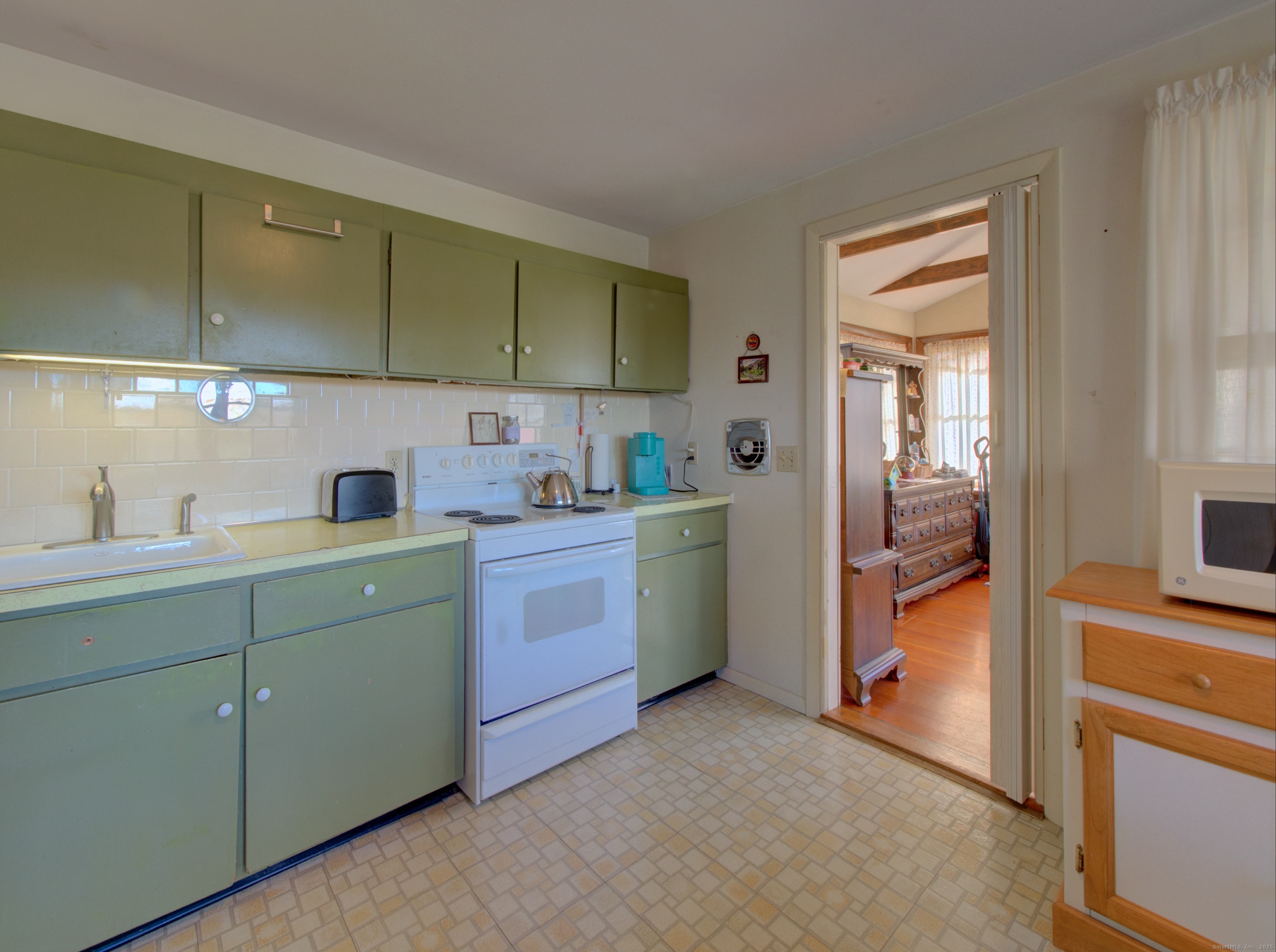 5 Sachem Lane Ledyard, CT 06339 - Photo 5 of 36 a kitchen with a sink and cabinets