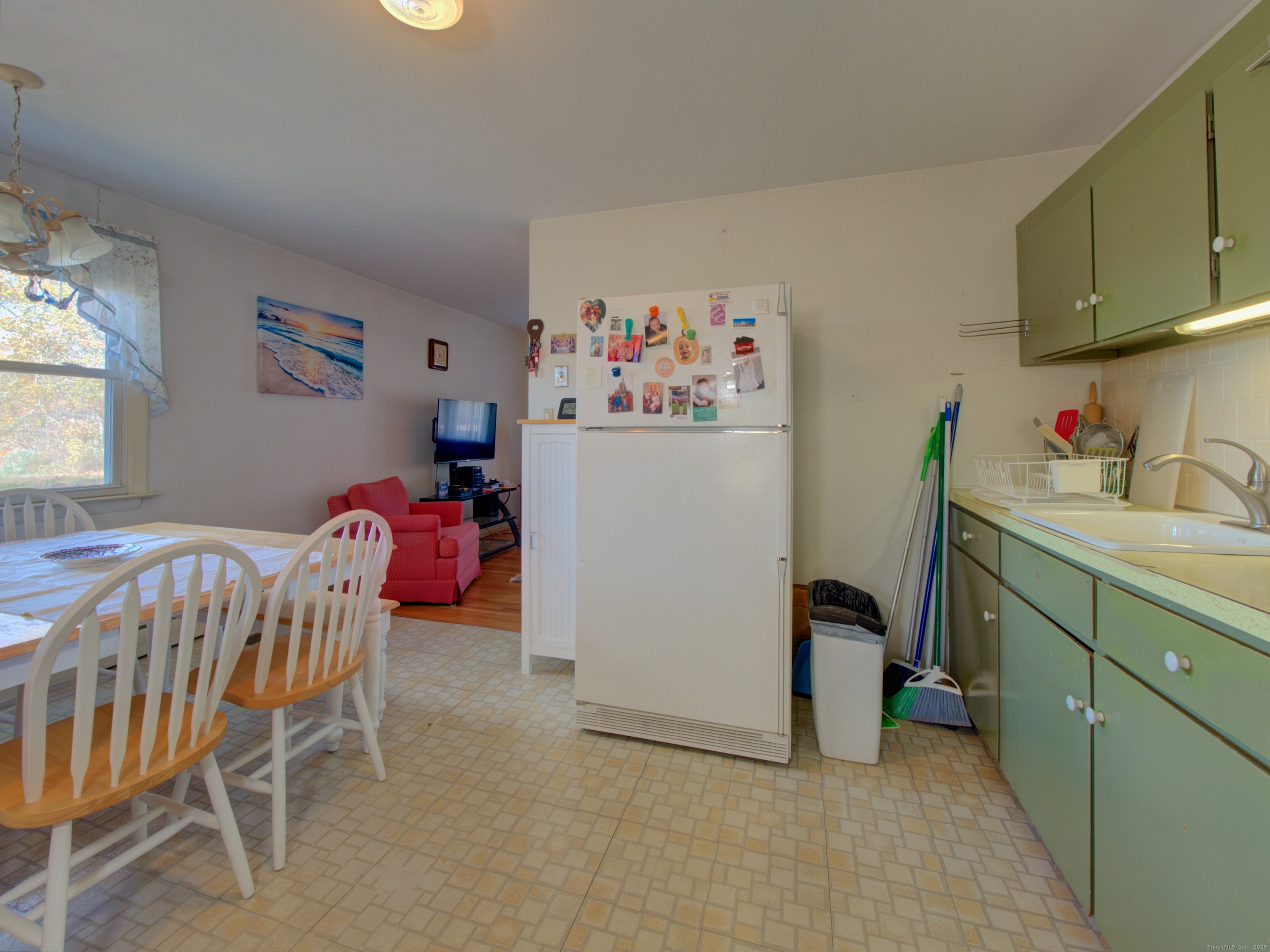 5 Sachem Lane Ledyard, CT 06339 - Photo 7 of 36 a bedroom with a baby bed a desk and chair with wooden floor
