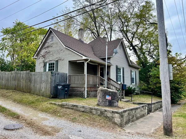 a view of a house with a yard and plants