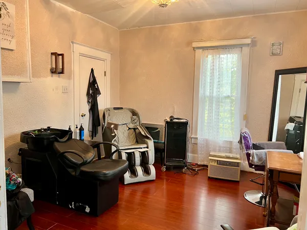 a view of a workspace with furniture and a gym