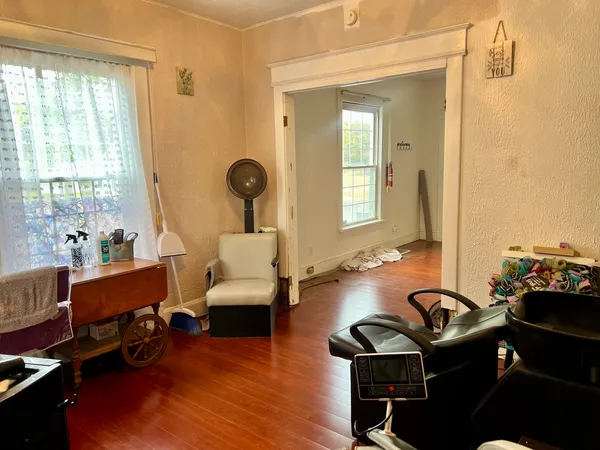 a living room with furniture and wooden floor