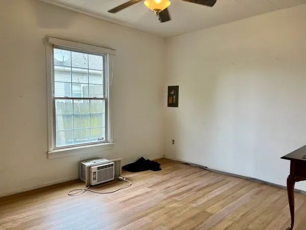 wooden floor in an empty room with a window