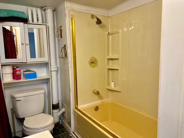 a bathroom with a tub and a shower