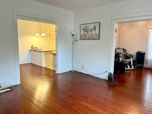 a view of a room with wooden floor and a window