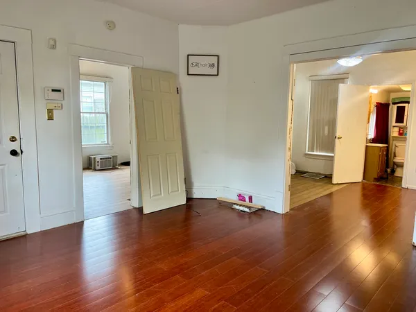 wooden floor in an empty room with a window