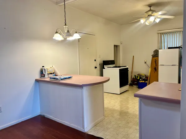 a kitchen with a sink a refrigerator and a stove