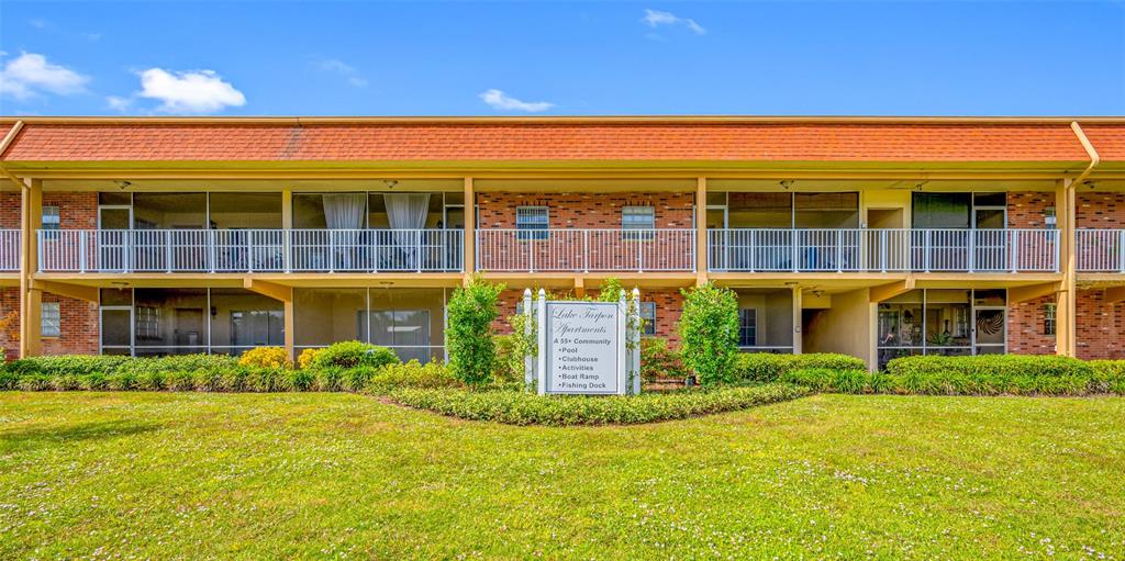 50 Liberty Way, Unit 10 Palm Harbor, FL 34684 - Photo 1 of 23 a front view of a building with a garden