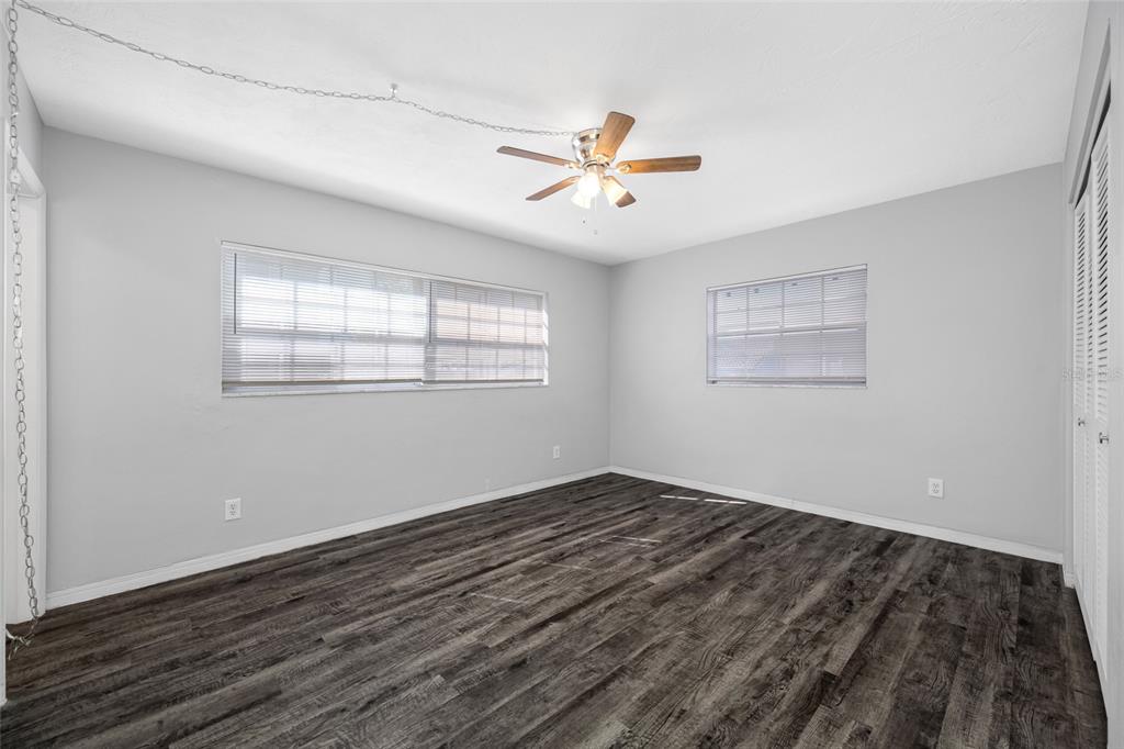 50 Liberty Way, Unit 10 Palm Harbor, FL 34684 - Photo 12 of 23 a view of empty room with wooden floor and fan
