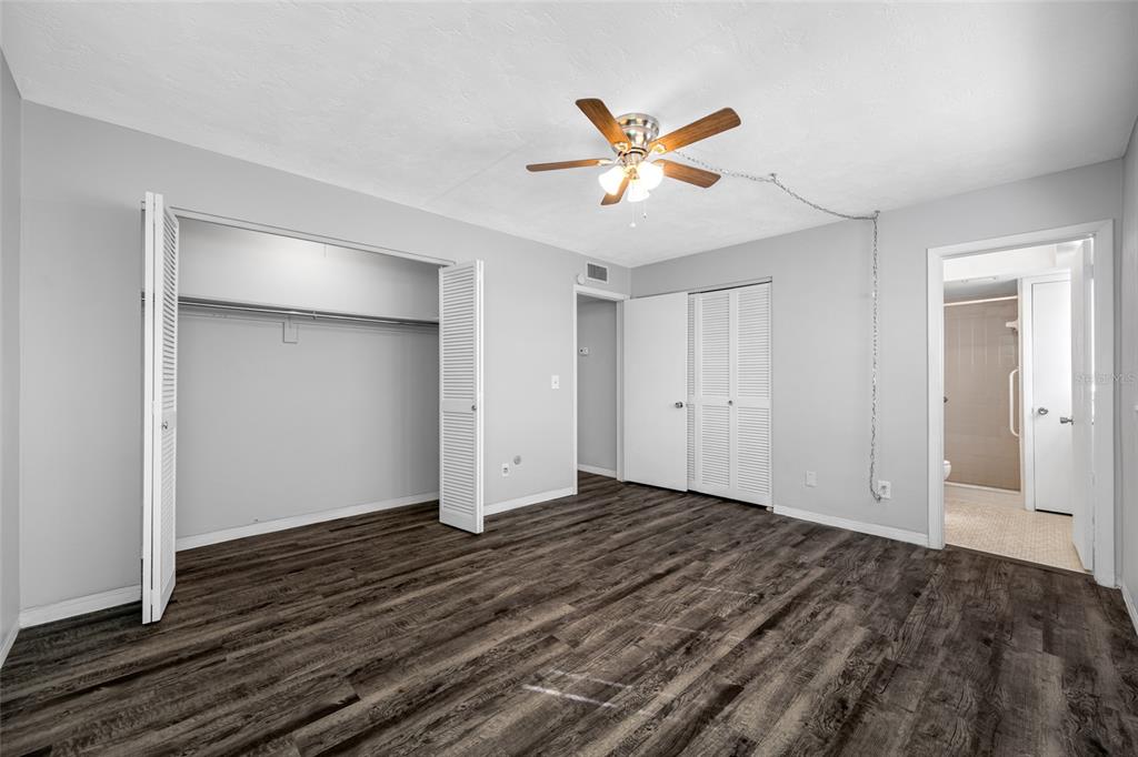 50 Liberty Way, Unit 10 Palm Harbor, FL 34684 - Photo 13 of 23 a view of an empty room and wooden floor