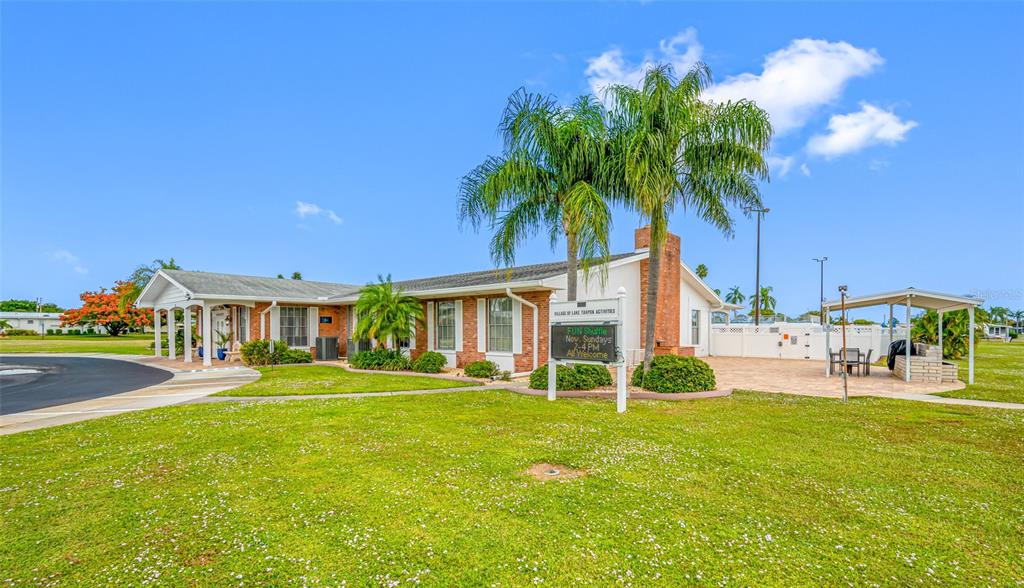 50 Liberty Way, Unit 10 Palm Harbor, FL 34684 - Photo 20 of 23 a front view of house with yard and green space