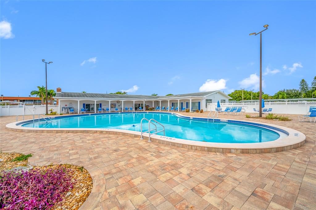 50 Liberty Way, Unit 10 Palm Harbor, FL 34684 - Photo 21 of 23 a view of a swimming pool with a yard