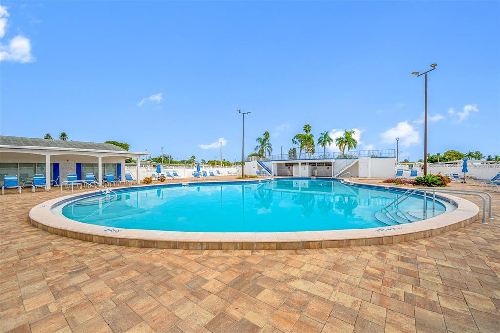 50 Liberty Way, Unit 10 Palm Harbor, FL 34684 - Photo 22 of 23 a swimming pool with outdoor seating and yard