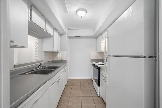 a kitchen that has a sink and a stove