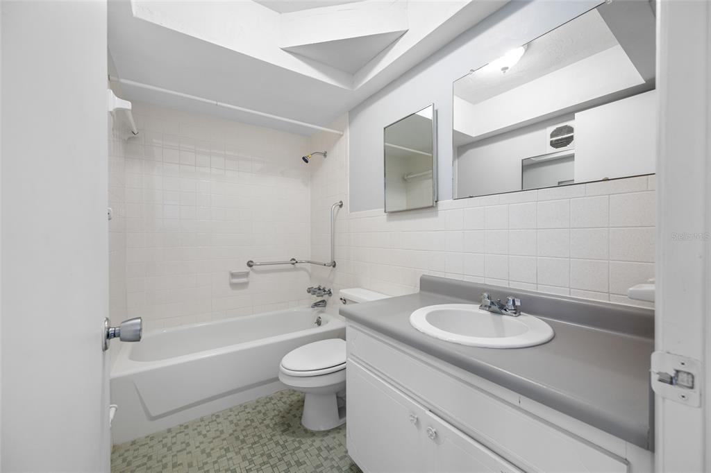 50 Liberty Way, Unit 10 Palm Harbor, FL 34684 - Photo 9 of 23 a bathroom with a sink toilet and shower