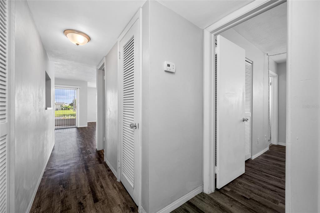 50 Liberty Way, Unit 10 Palm Harbor, FL 34684 - Photo 10 of 23 a view of a hallway with wooden floor and staircase