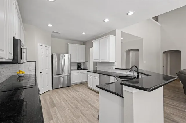 a kitchen with refrigerator and window