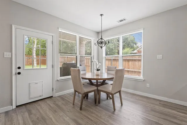 a view of a dining room with furniture windows and wooden floor