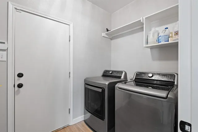 a view of storage and utility room with washer and dryer