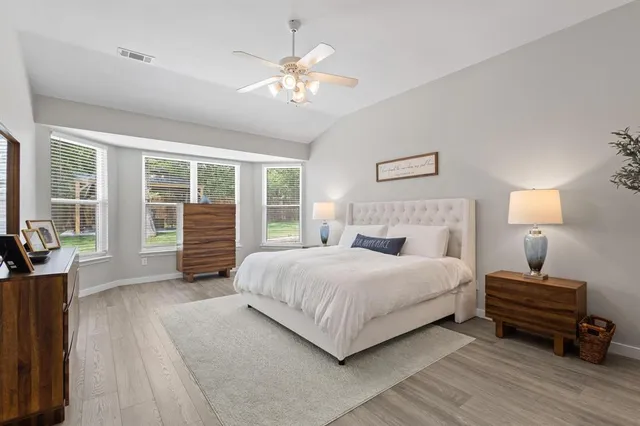 a bedroom with a bed and wooden floor