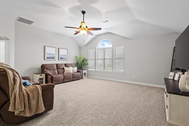 a living room with furniture a chandelier and a window