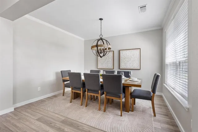 a view of a dining room with furniture window and wooden floor