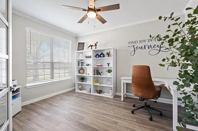 a view of a workspace with furniture and a window