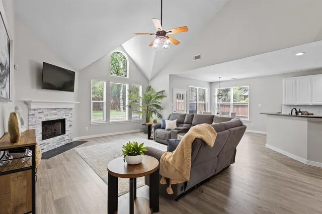 a living room with furniture a fireplace and a flat screen tv