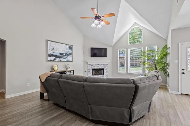 a living room with furniture a fireplace and a flat screen tv