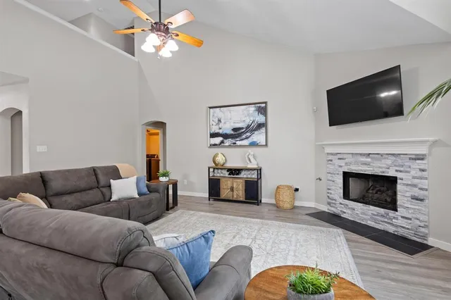 a living room with furniture fireplace and flat screen tv