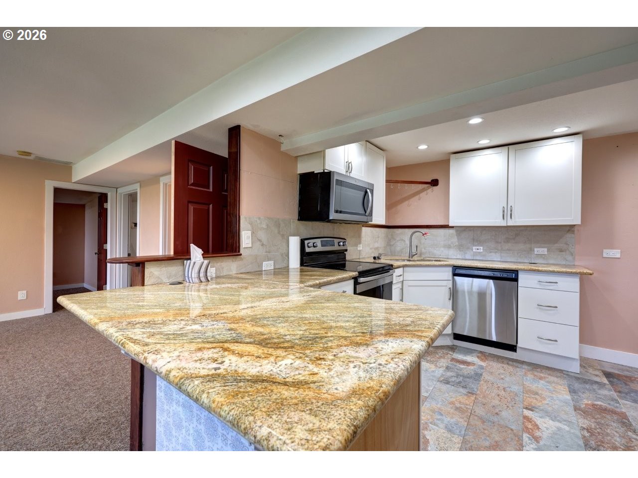 91828 Akerstedt Road Astoria, OR 97103 - Photo 26 of 48 a kitchen with kitchen island granite countertop a sink and stove