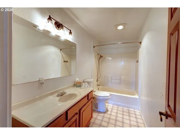 a kitchen with a stove a refrigerator and a wooden floor