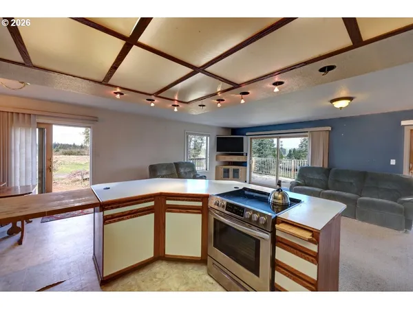 a kitchen with stainless steel appliances granite countertop a sink a stove and a wooden floors