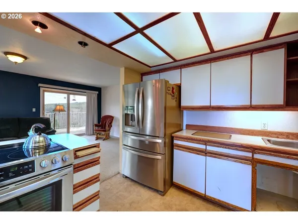 a kitchen with stainless steel appliances granite countertop a refrigerator and a stove top oven