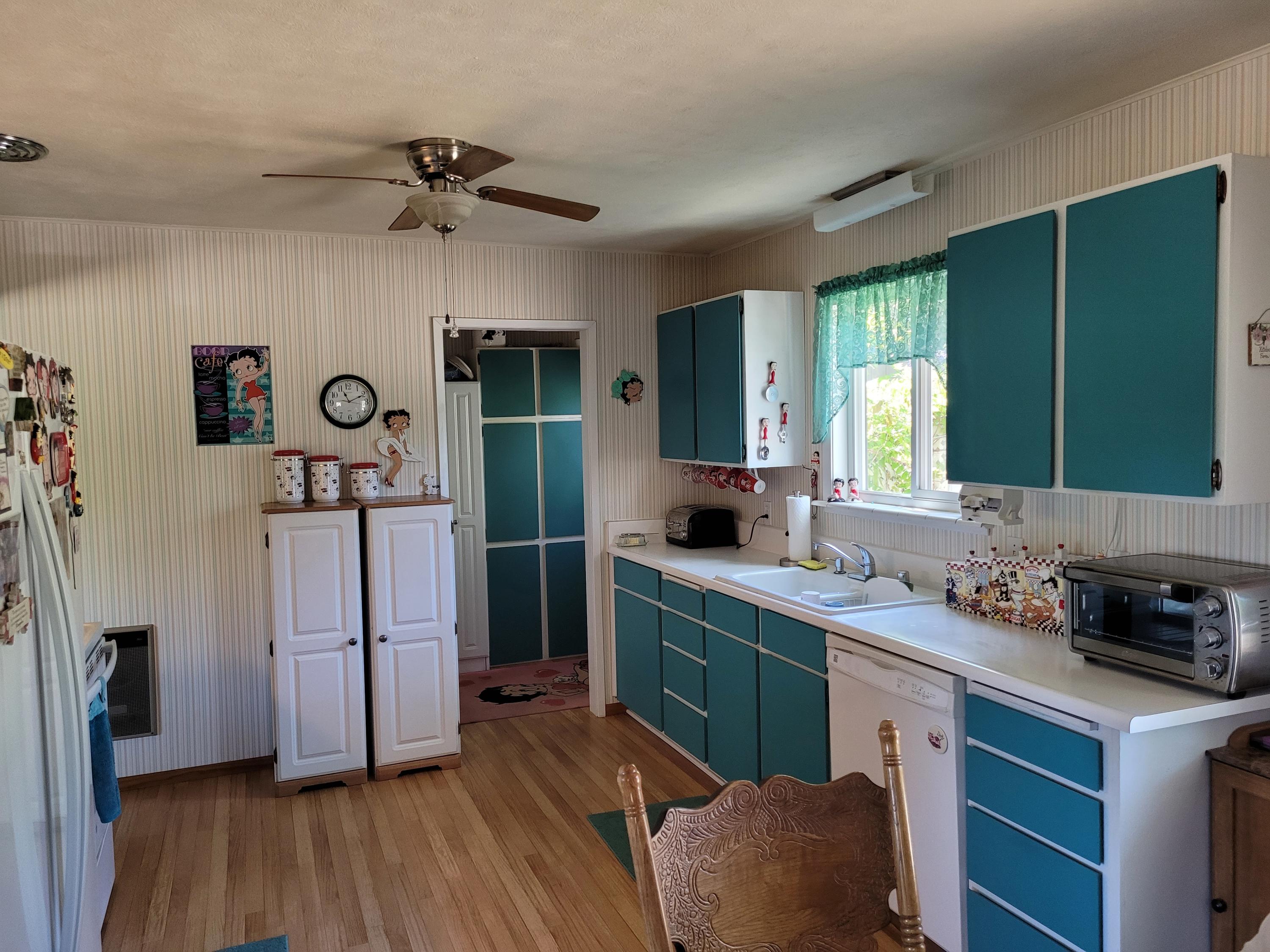 16172 Hope So Mine Road Redding, CA 96001 - Photo 6 of 26 a kitchen with kitchen island a counter top space a sink stainless steel appliances and cabinets