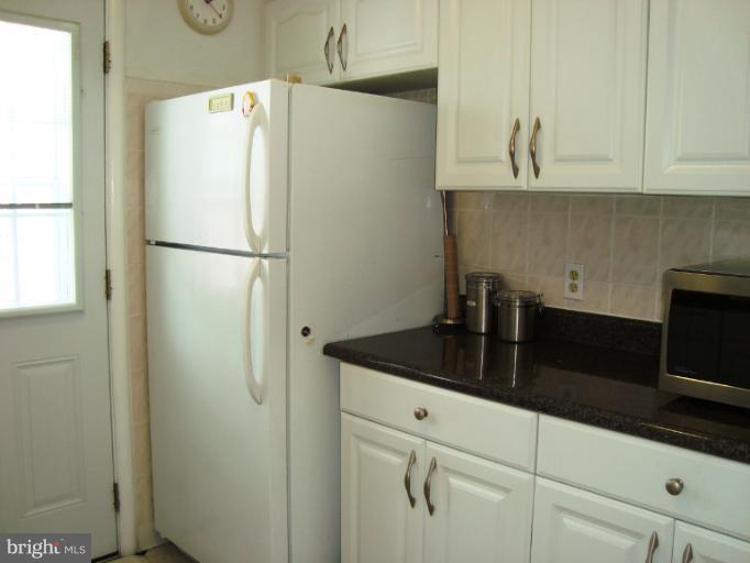 a white refrigerator freezer sitting in a kitchen