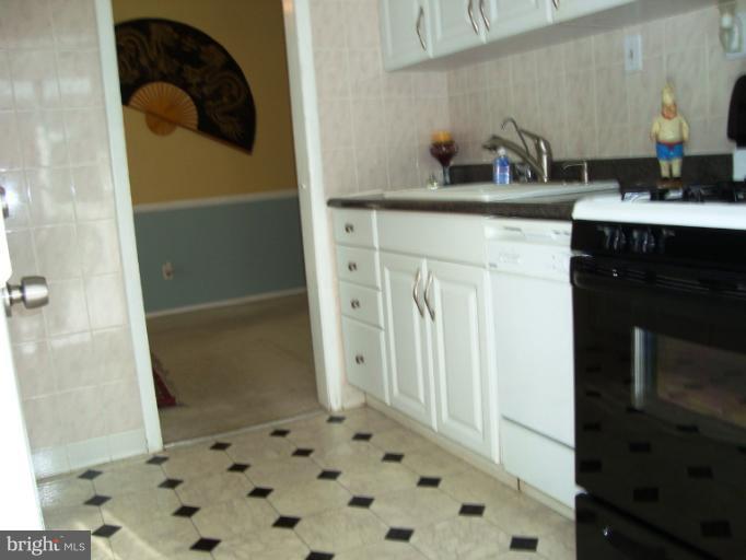 11423 Veirs Mill Road Silver Spring, MD 20902 - Photo 3 of 25 a bathroom with a sink and a mirror