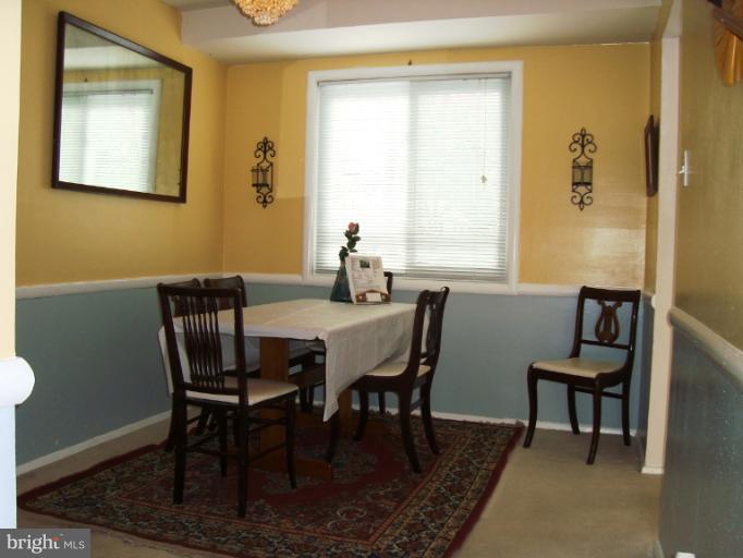 11423 Veirs Mill Road Silver Spring, MD 20902 - Photo 4 of 25 a view of a dining room with furniture and a window