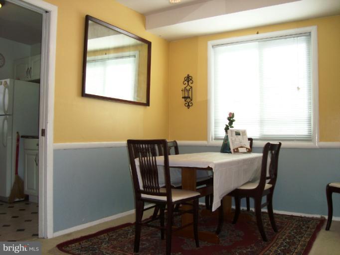 11423 Veirs Mill Road Silver Spring, MD 20902 - Photo 5 of 25 a view of a dining room with furniture and a window