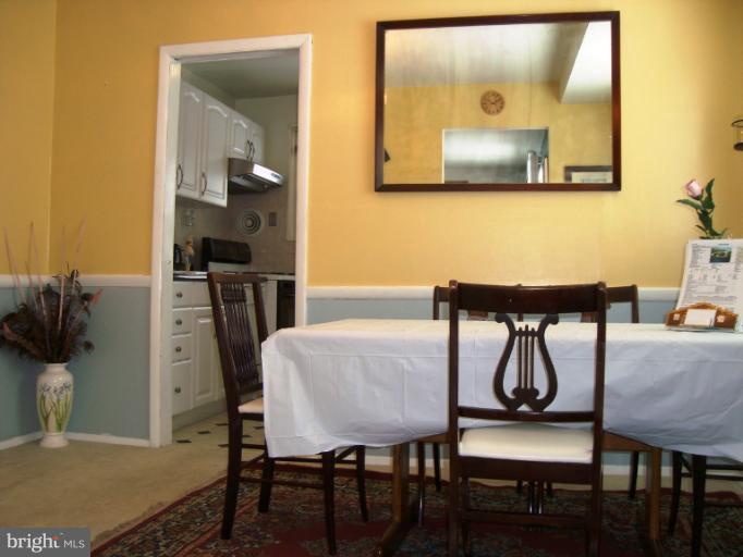 11423 Veirs Mill Road Silver Spring, MD 20902 - Photo 9 of 25 a dinning room with furniture and wooden floor