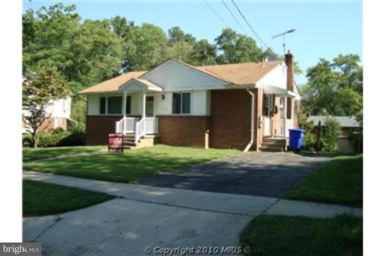 11423 Veirs Mill Road Silver Spring, MD 20902 - Photo 10 of 25 a front view of a house with a yard