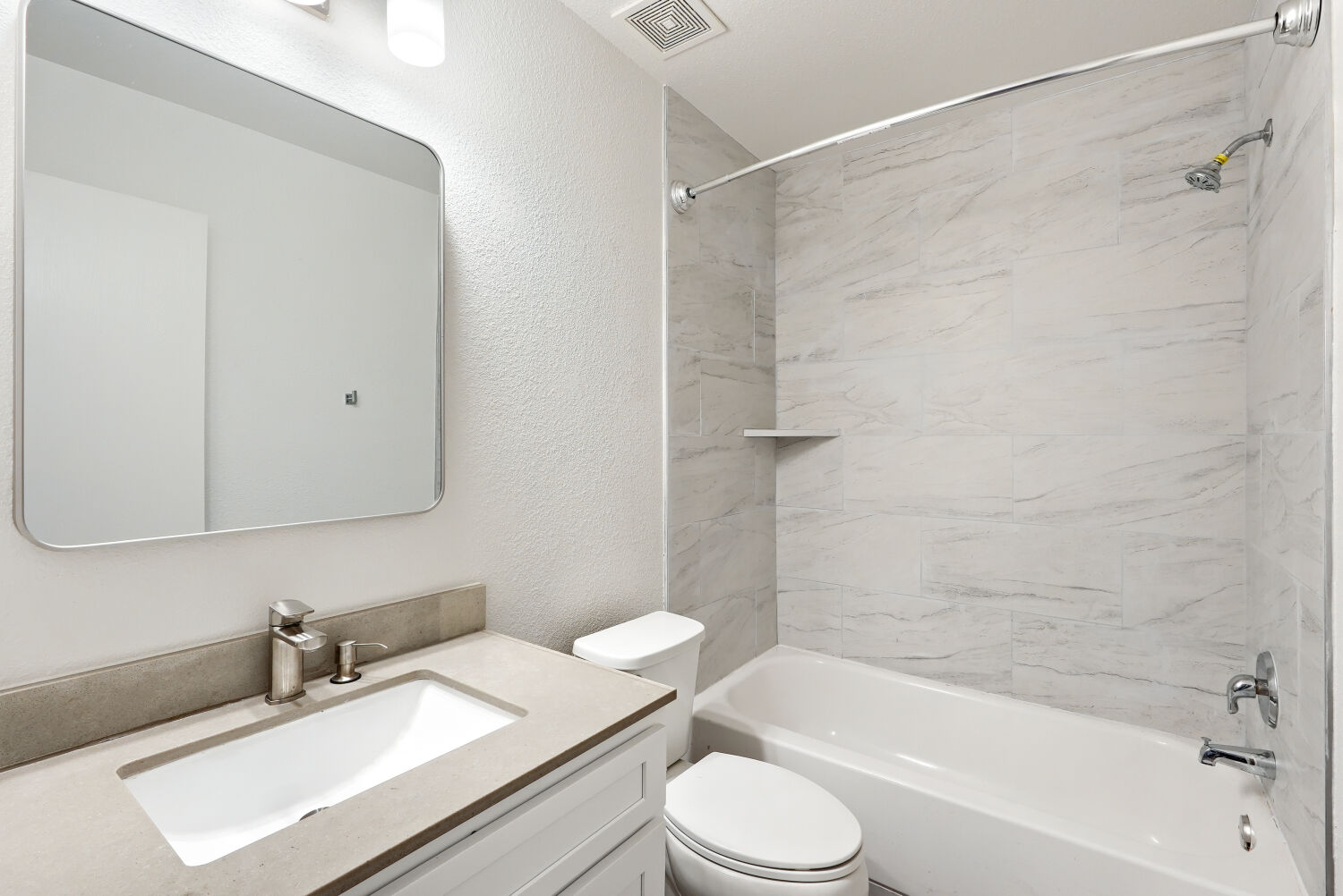 184 Unity Kyle, TX 78640 - Photo 11 of 11 Bathroom featuring a vanity with a rectangular sink, a bathtub/shower combo with updated tile back splash